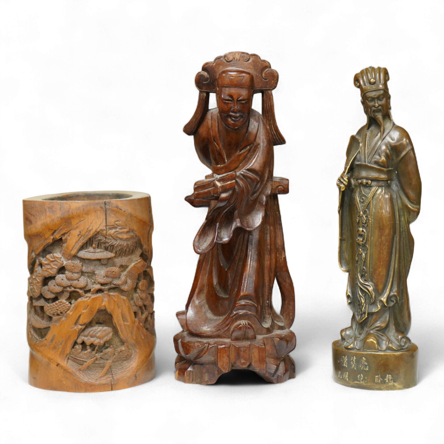 A bronzed Chinese figure of Qianlong, a carved bamboo brush pot and a hardwood figure, largest 20cm high
